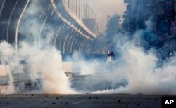 Police fire tear gas to disperse crowd protesting against the government in Rawalpindi, Pakistan, Friday, Oct. 28, 2016.