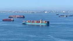 FILE - Container ships wait off the coast of the congested Ports of Los Angeles and Long Beach in Long Beach, California, Oct. 1, 2021.