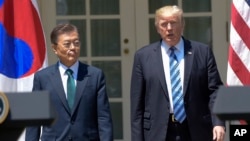 President Donald Trump and South Korean President Moon Jae-in arrive in the Rose Garden of the White House in Washington, June 30, 2017, to make statements.