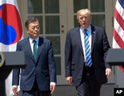 FILE - President Donald Trump and South Korean President Moon Jae-in stand in the Rose Garden of the White House in Washington.