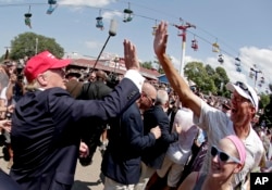 Republican presidential candidate Donald Trump greets the crowd at the Iowa State Fair in Des Moines, Aug. 15, 2015.