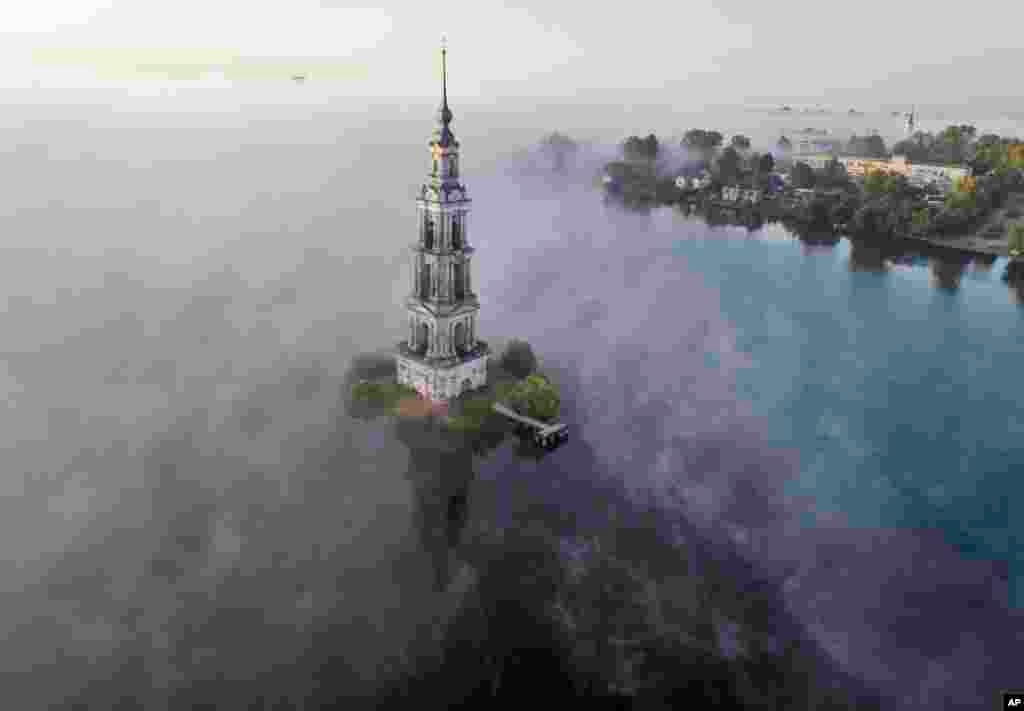 The famous Kalyazin Bell Tower, part of the submerged monastery of St. Nicholas, is seen in the morning fog in the town of Kalyazin located on the Volga River, 180 km (111 miles) north-east of Moscow, Russia.
