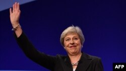 Britain's Prime Minister Theresa May waves after giving her keynote address on the fourth and final day of the Conservative Party Conference 2018 at the International Convention Centre in Birmingham, England, Oct. 3, 2018.