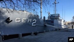 A North Korean military security guard keeps watch over the USS Pueblo in Pyongyang, North Korea, Jan. 24, 2108.