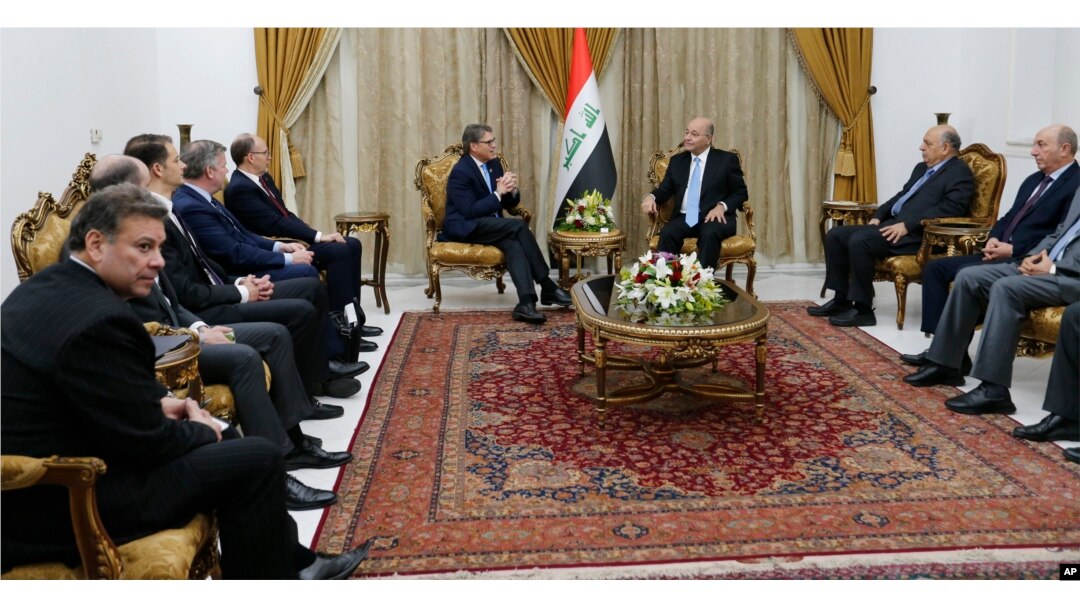 Iraq's President Barham Salih, right, meets with U.S. Energy Secretary Rick Perry, in Baghdad, Dec. 11, 2018.