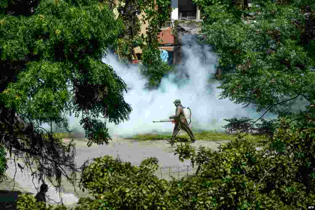 A worker releases disinfectant in a neighborhood during a government-ordered nationwide lockdown as a preventive measure against the new coronavirus, in Islamabad, Pakistan.