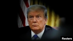 FILE - U.S. President Donald Trump looks on during a meeting with China's Vice Premier Liu He in the Oval Office at the White House in Washington, Feb. 22, 2019.