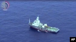 This still image taken from video posted Saturday, May 21, 2016, on the official Facebook page of the Egyptian Armed Forces spokesman shows an Egyptian ship collecting wreckage of EgyptAir flight 804.