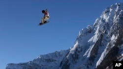 Shaun White of the United States takes a jump during a Snowboard Slopestyle training session at the Rosa Khutor Extreme Park, prior to the 2014 Winter Olympics, Feb. 4, 2014, in Krasnaya Polyana, Russia. 