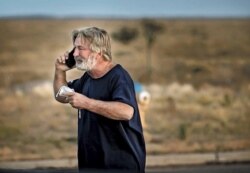 Alec Baldwin speaks on the phone in the parking lot outside the Santa Fe County Sheriff's Office in Santa Fe, N.M., after he was questioned about a shooting on the set of the film "Rust" on the outskirts of Santa Fe, Thursday, Oct. 21, 2021.