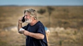 Alec Baldwin speaks on the phone in the parking lot outside the Santa Fe County Sheriff's Office in Santa Fe, N.M., after he was questioned about a shooting on the set of the film 