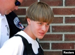 Police lead suspected shooter Dylann Roof into the courthouse in Shelby, North Carolina, June 18, 2015.