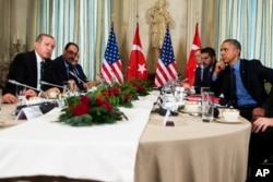 FILE - U.S. President Barack Obama, right, holds a bilateral meeting with Turkish President Recep Tayyip Erdogan, in Paris, Dec. 1, 2015. The leaders discussed the continuing crisis in Syria, and the fight against the Islamic State group.