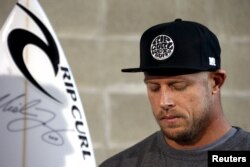 Surfing champion Mick Fanning of Australia, who survived a shark attack, reacts at a news conference in Sydney, July 21, 2015.