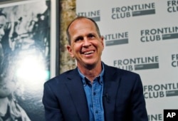 FILE - Freed Al Jazeera journalist Peter Greste smiles as he answers a question during an event in central London, Feb. 19, 2015.