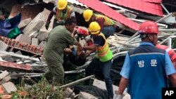 Tim penyelamat melakukan evakuasi korban dari reruntuhan gedung yang ambruk di Sihanoukville, Kamboja, Sabtu (22/6). 