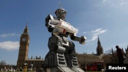 A robot is pictured in front of the Houses of Parliament and Westminster Abbey as part of the Campaign to Stop Killer Robots in London, April 23, 2013. 