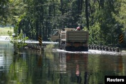 Members of the 1st Combat Engineer Company of the U.S. National Guard of Laurinburg, North Carolina, navigate flood waters in the aftermath of Hurricane Florence, now downgraded to a tropical depression, in Whiteville, North Carolina, Sept. 18, 2018.