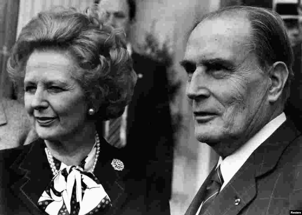 Then British Prime Minister Margaret Thatcher and French President Francois Mitterrand pose for the media after a meeting about nuclear arms control at the Chateau de Benouville in Normandy, western France, March 23, 1987. 