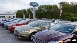 In this Wednesday, May 8, 2013 photo, new 2013 Ford Fusions are seen at an automobile dealer in Zelienople, Pennsylvania. (AP Photo/Keith Srakocic)