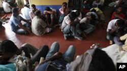 Would-be illegal asylum seekers from Sri Lanka are seen at a police station in Colombo after attempting to sail to Australia illegally by boat, May 28, 2012.