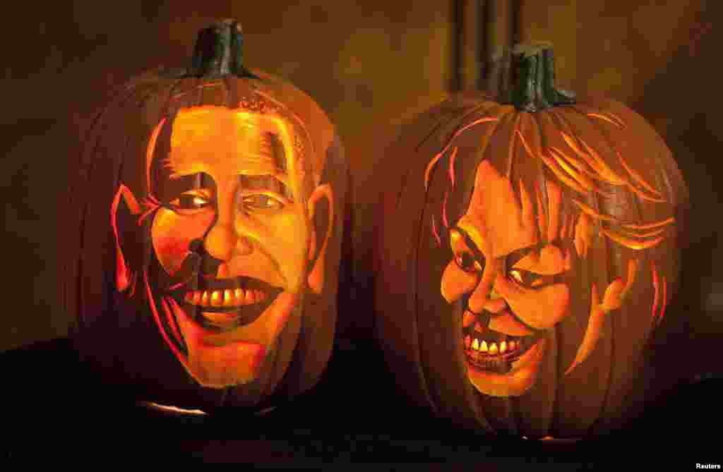 Pumpkins carved in the likeness of U.S. President Barack Obama and First Lady Michelle Obama are lit at Madame Tussauds in New York. 
