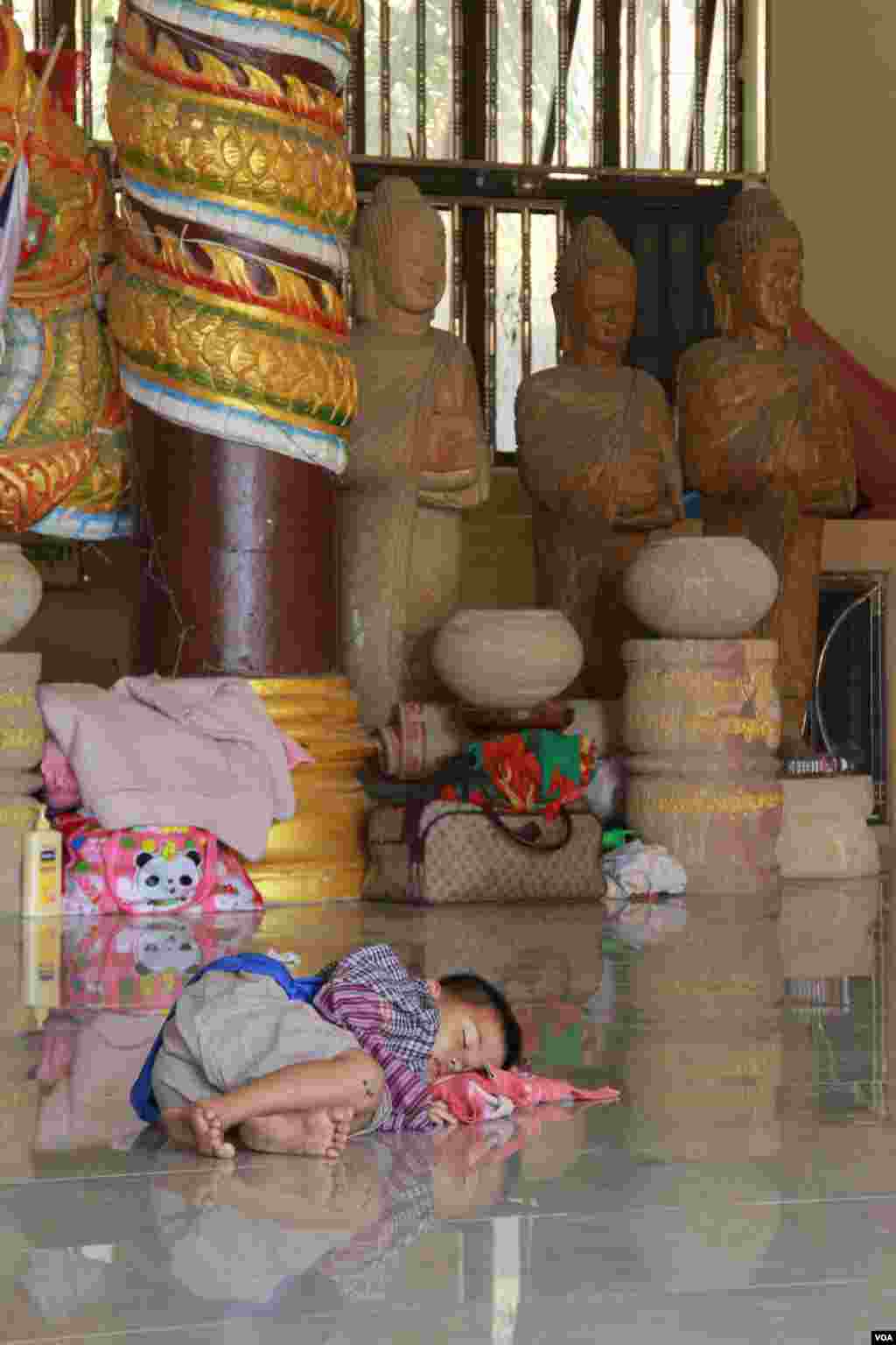 A boy is taking a nap during an afternoon in Samakki Raingsey temple in Phnom Penh, Cambodia, February 5, 2015.