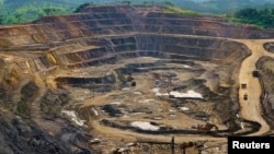 File - Excavators and drillers at work in an open pit at Tenke Fungurume, a copper and cobalt mine 110 kilometers northwest of Lubumbashi in Congo's copper-producing south, owned by miner Freeport McMoRan, Lundin Mining and state mining company Gecamines.