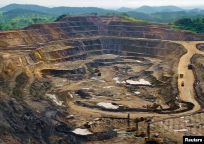 FILE - Excavators and drillers work in an open pit at a copper and cobalt mine in Congo's copper-producing south, Jan. 29, 2013.