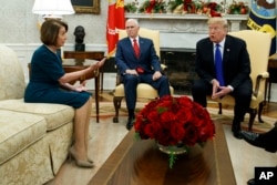 FILE - Vice President Mike Pence, center, looks on as House Minority Leader Rep. Nancy Pelosi, D-Calif., and President Donald Trump argue during a meeting in the Oval Office of the White House, Dec. 11, 2018.