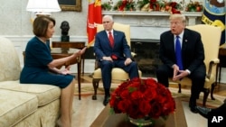 Vice President Mike Pence, center, looks on as House Minority Leader Rep. Nancy Pelosi, D-Calif., and President Donald Trump argue during a meeting in the Oval Office of the White House, Dec. 11, 2018, in Washington.