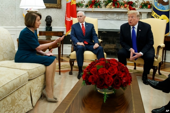 FILE - Vice President Mike Pence, center, looks on as House Minority Leader, now Speaker of the House, Rep. Nancy Pelosi, a California Democrat, and President Donald Trump argue during a meeting in the Oval Office of the White House, Dec. 11, 2018, in Washington.