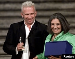 FILE - Fashion designers Jean Paul Gaultier and Laura Biagiotti during Rome's Spanish Steps fashion gala July 19, 2000.