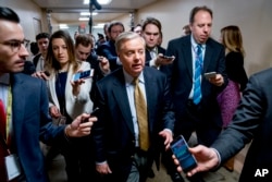 Sen. Lindsey Graham, R-S.C., speaks to reporters as he walks toward the Senate as Congress moves closer to the funding deadline to avoid a government shutdown on Capitol Hill in Washington, Jan. 18, 2018.