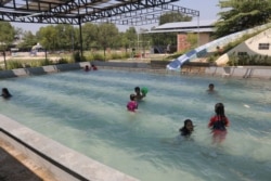 School and visiting children play in one of the shallower pools shaded from the burning afternoon sun at Seametrey Children's Village, in Chambork Trop village, Kandal province, on Sept. 24, 2019. (Rithy Odom/VOA Khmer)