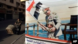 A poster showing Egyptian President Abdel-Fattah el-Sissi, is displayed in Tahrir Square, which was the focal point of the Jan. 25, 2011 Egyptian uprising, in Cairo, March 22, 2018.