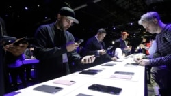 People look at different Samsung Galaxy S20 5G phones displayed at the Unpacked 2020 event in San Francisco, Tuesday, Feb. 11, 2020. (AP Photo/Jeff Chiu)