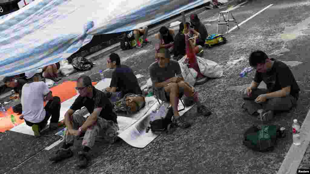 Protesters of the Occupy Central movement rest under a tent on a main road at the Mong Kok shopping district in Hong Kong, October 6, 2014.