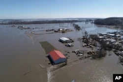 This March 20, 2019, aerial photo shows flooding near the Platte River in in Plattsmouth, Neb., south of Omaha. The National Weather Service is warning that flooding in parts of South Dakota and northern Iowa could soon reach historic levels.