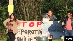 Morristown residents hold poster that says "Stop Deporting Families". (Photo: Marissa Melton / VOA)