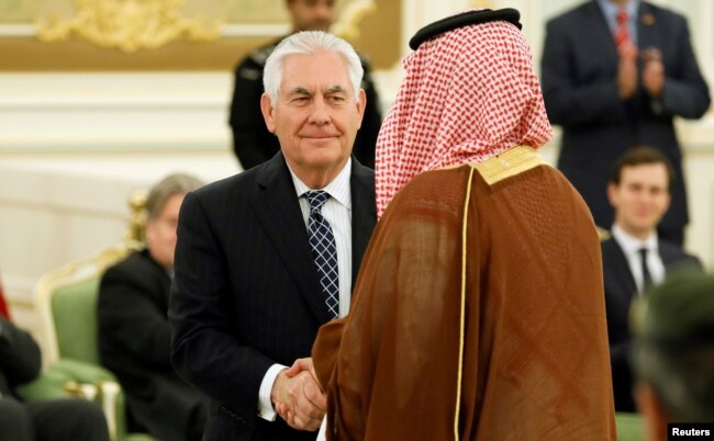 FILE - U.S. Secretary of State Rex Tillerson shakes hands with a participant as he attends a signing ceremony between U.S. President Donald Trump and Saudi Arabia