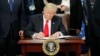 President Donald Trump signs an executive order fo