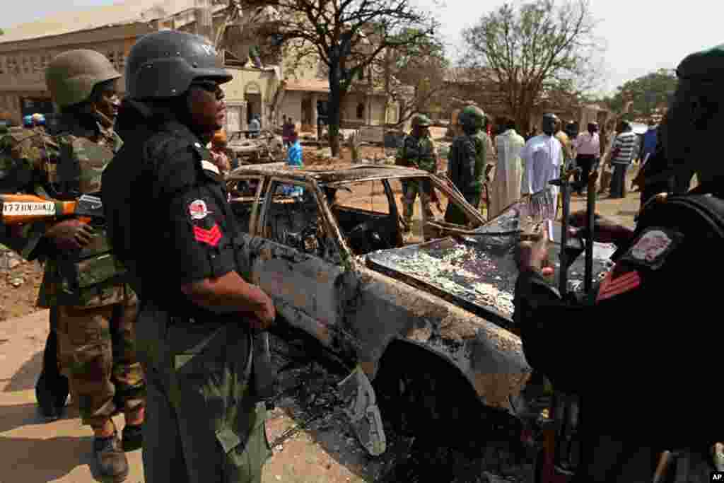 Security forces view the scene of a bomb explosion at St. Theresa Catholic Church at outside Nigeria's capital Abuja, on December 25, 2011. (Reuters)