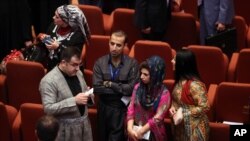 FILE - Newly elected Iraqi Kurd members of parliament attend the first session of parliament in the heavily fortified Green Zone in Baghdad, July 1, 2014. 