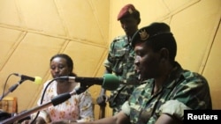 FILE - Major General Godefroid Niyombare, one of the four people sanctioned, addresses the nation inside the Radio Publique Africaine (RPA) broadcasting studios in Burundi's capital Bujumbura, May 13, 2015. 