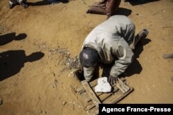 Jonarson Revoria, 73, a farmer, shows a small basin dug in the ground to collect rainwater in the village of Ankilidoga, Commune of Sampona, Madagascar, August 31, 2021. But it has not been filled since July.