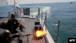 Bulgarian marines fire machine guns on board a Bulgarian navy frigate ship during BREEZE 2014 military drill in the Black Sea, July 11, 2014. 