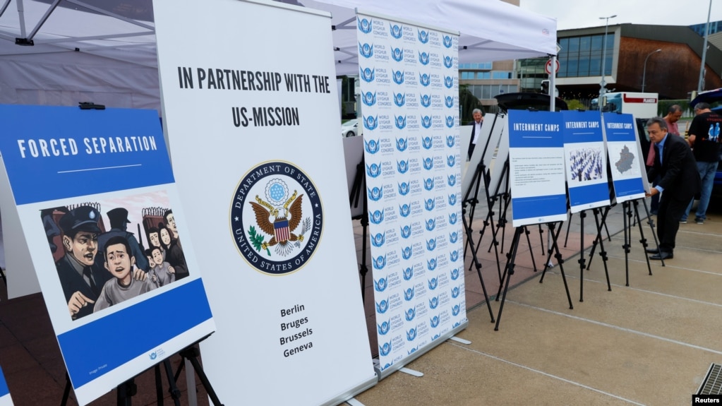 Dolkun Isa, President of the World Uyghur Congress, sets up the display of people who are missing or alleged to be held in Chinese-run camps in Xinjiang, China, in front of the United Nations on Sept. 16, 2021.