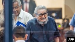 Shining Path leftist guerrilla group leader Abimael Guzman arrives at his trial at a military base in Callao, outskirts of Lima, Feb. 28, 2017, together with 12 other leaders accused of a variety of charges from terrorism to drug trafficking. 