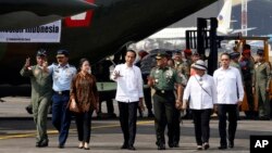 FILE - Indonesia President Joko Widodo, center, talks with Indonesian Army Chief of Staff Gen. Gatot Nurmantyo, during inspection of aids for Rohingya before its departure at Halim Perdanakusuma air base in Jakarta, Sept. 13, 2017. 